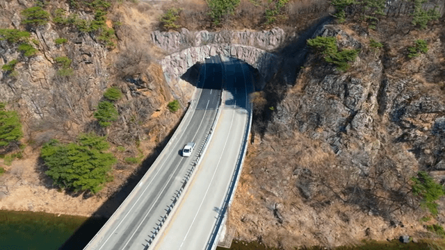 Road tunnel through rocky mountains