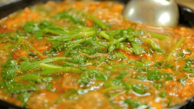 Spicy Bulgogi Hot Pot with Crown Daisy boiling in a pot