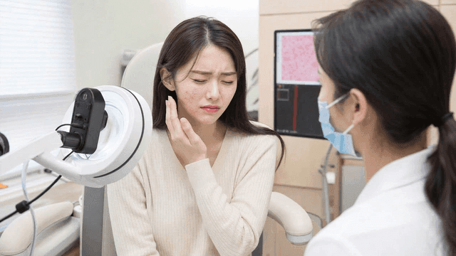 Woman consulting with dermatologist