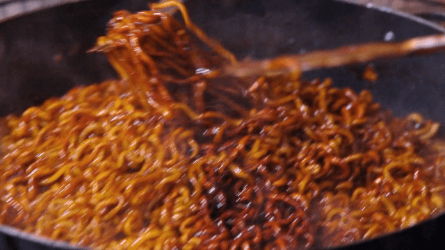 Cooking spicy Korean noodles in a pot