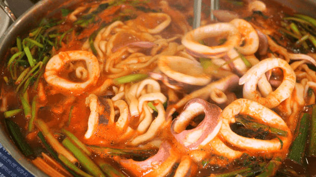 Spicy squid kalguksu boiling in pot