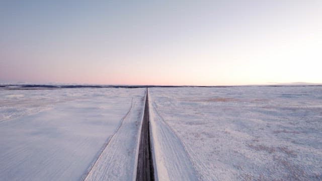 Long road through a snowy landscape