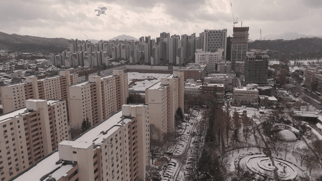 Snow-covered cityscape with tall buildings
