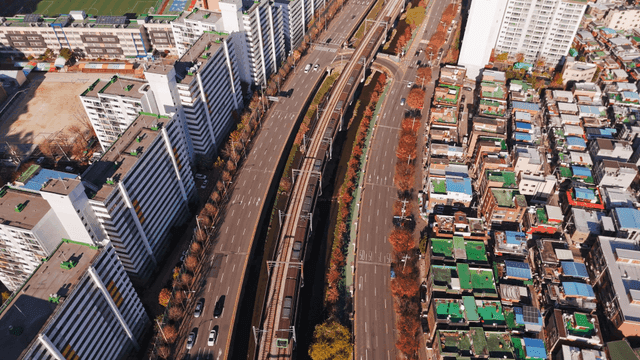 Aerial view of city with roads and train tracks