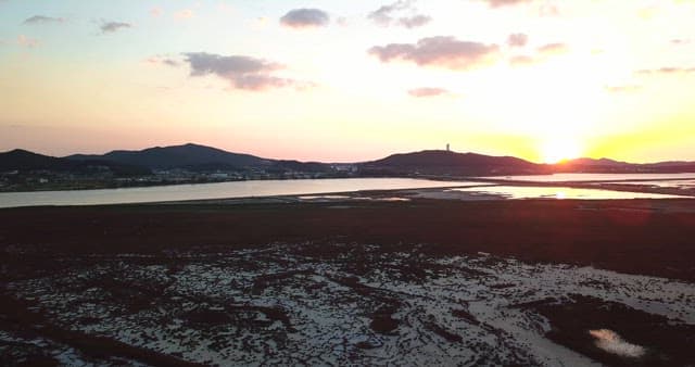 Sunset over a serene coastal landscape