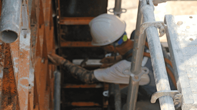Construction workers assembling scaffolding