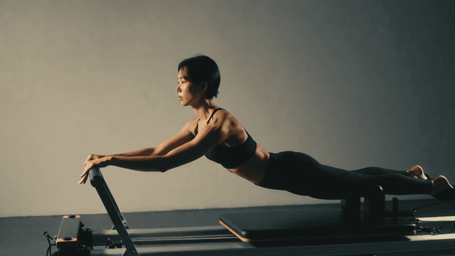 Short-haired woman practicing Pilates