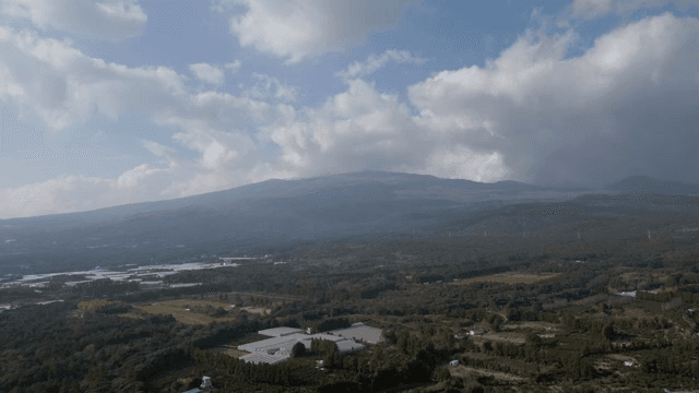 A vast landscape with mountains and fields