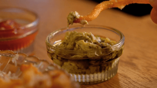 Dipping a fry into guacamole