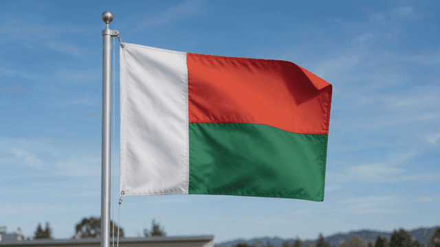 Flag of Republic of Madagascar fluttering under clear sky