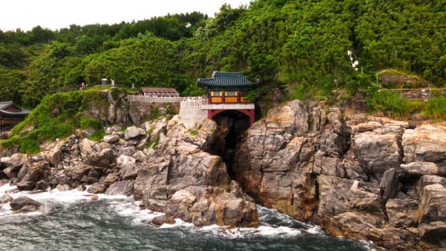 Traditional Korean temple on a coastal cliff