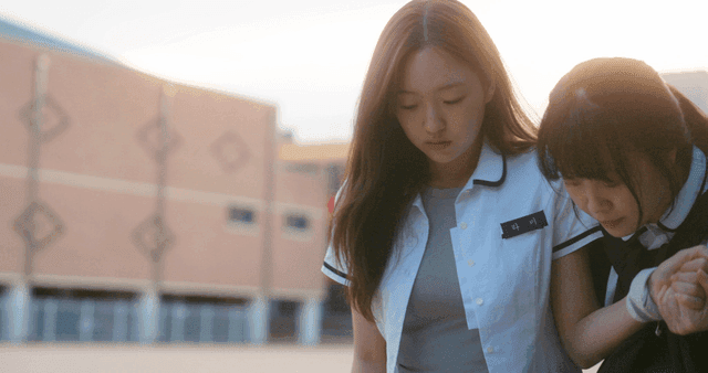Limping schoolgirl with a friend supporting her