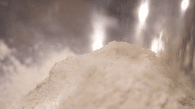 Flour being poured into a mixing bowl
