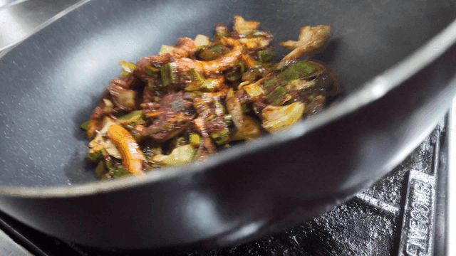 Stir-frying octopus and vegetables in a pan