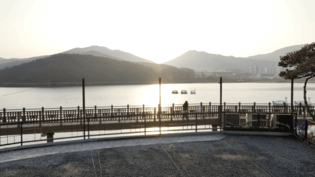 Tranquil lake with mountains visible at sunset