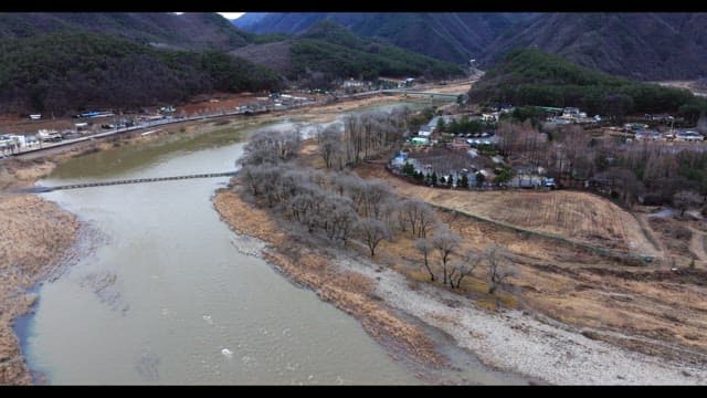 Village surrounded by rivers and lush green mountains