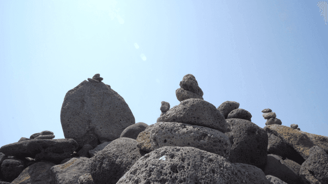 Stacked stones under a clear blue sky