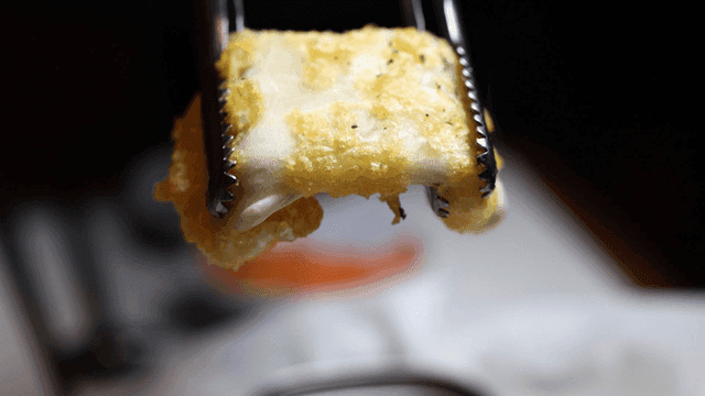 Fried cheese that you hold with tongs and stretch.