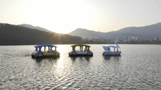 Sunset scenery and paddle boats on lake