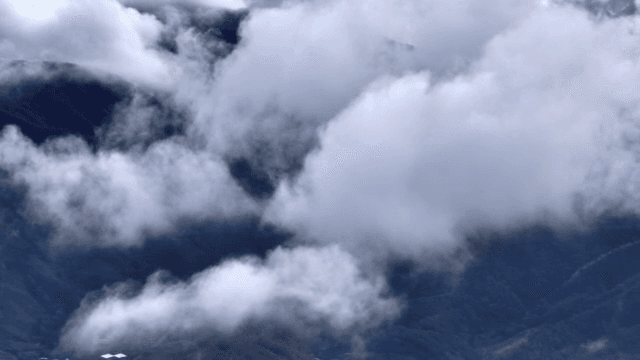 Clouds drifting over mountain peaks