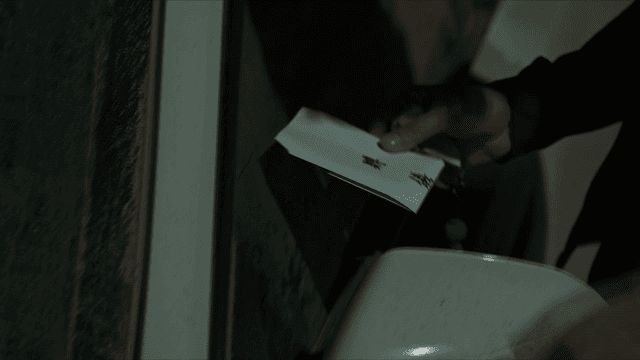 Hand that found condolence envelope in car's side mirror