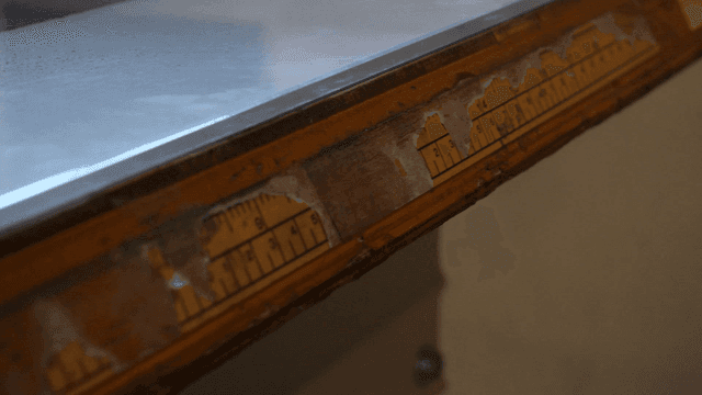 Close-up of old ruler on desk