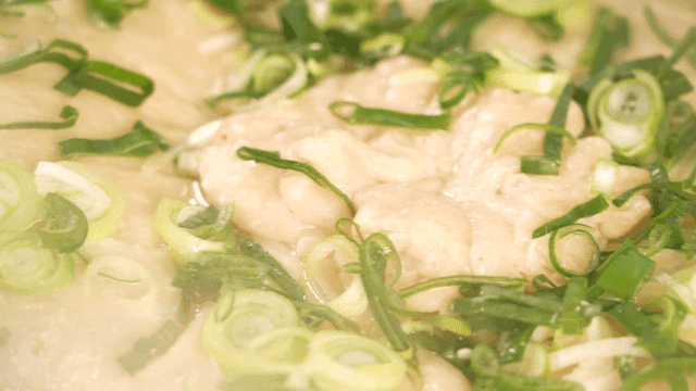 Large dumpling soup cooking in pan