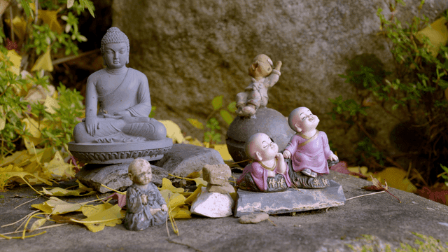 Buddhist statues surrounded by leaves