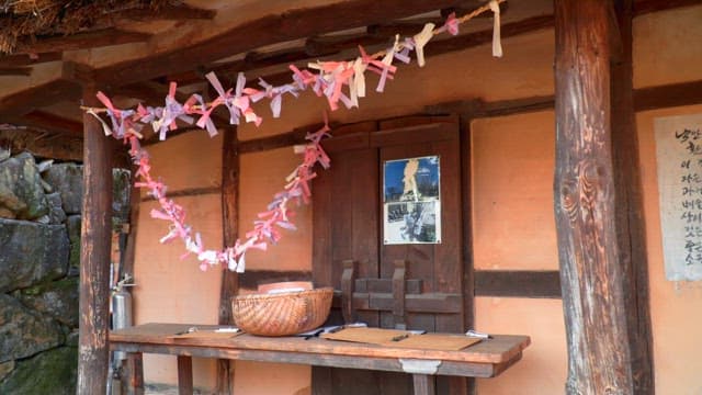 Traditional house decorated with ropes tied with papers with wishes written on them