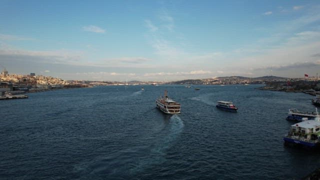 Boats Navigating Busy Harbor with City Skyline