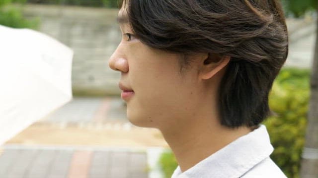 Man smiling while walking down the street