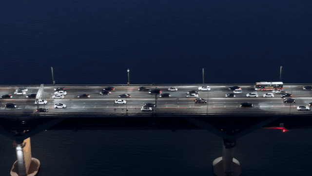 Cars driving on bridge over river