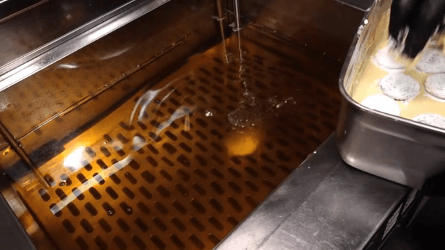 쿠키를 반죽에 담가 튀기는 장면