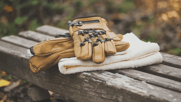 Gloves and towel on a wooden bench