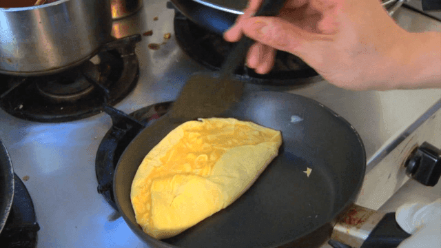 Frying pan omelet cooking on gas burner