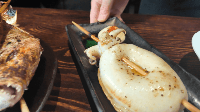 Grilled seafood skewers on a wooden table