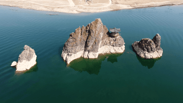 Traditional pavilion on rocky island