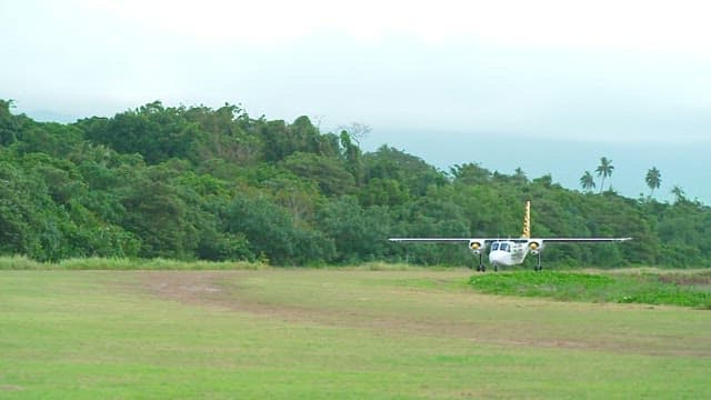 Small airplane on a grassy runway