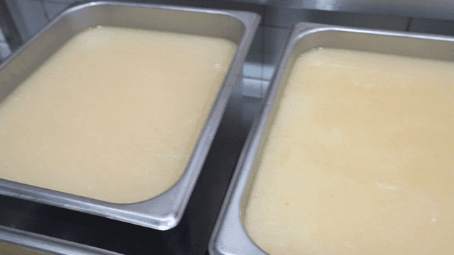 Large tray full of broth in kitchen