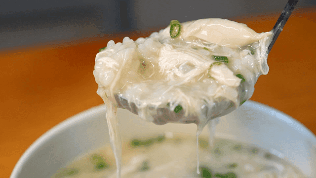 Ladle of steaming chicken porridge