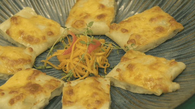 Cheese-topped dumplings on a plate