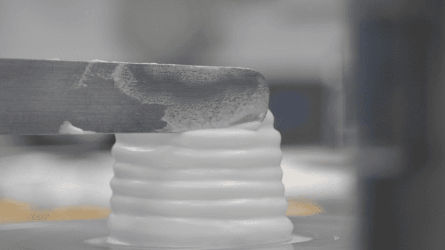 Icing being applied to a cake