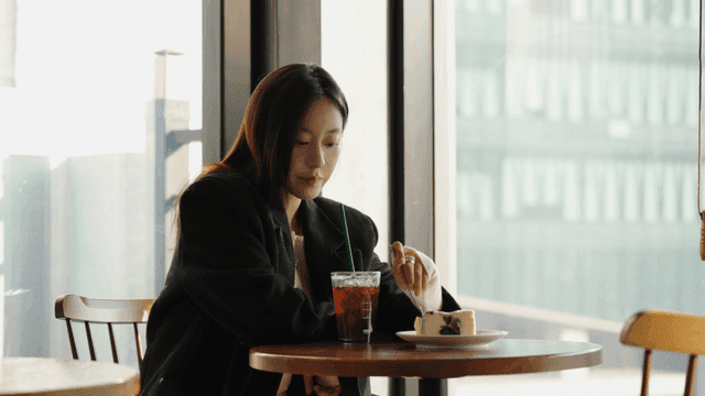 Woman enjoying a coffee and cake at a cafe