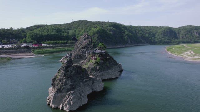 Gazebo on a Rocky Island in the River during the Daytime