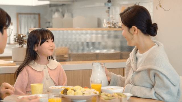 Mom pouring milk into baby's cereal
