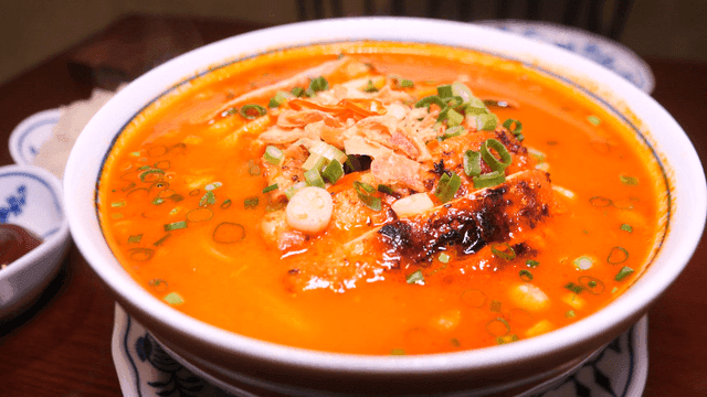 Bowl filled with spicy chicken rice noodles