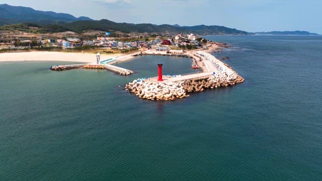 Coastal town with a red lighthouse