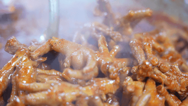 Spicy chicken feet being cooked in a pot