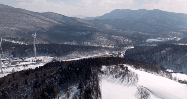Snowy mountains with wind turbines