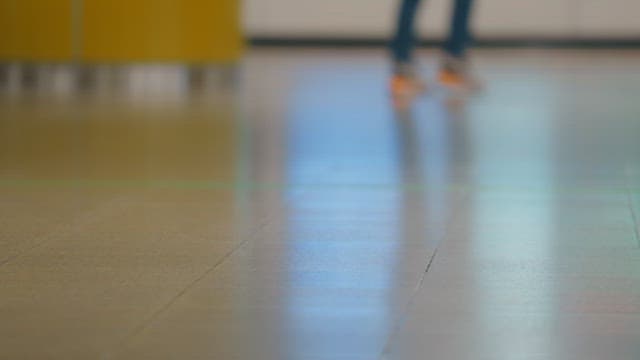 People walking in a busy indoor corridor